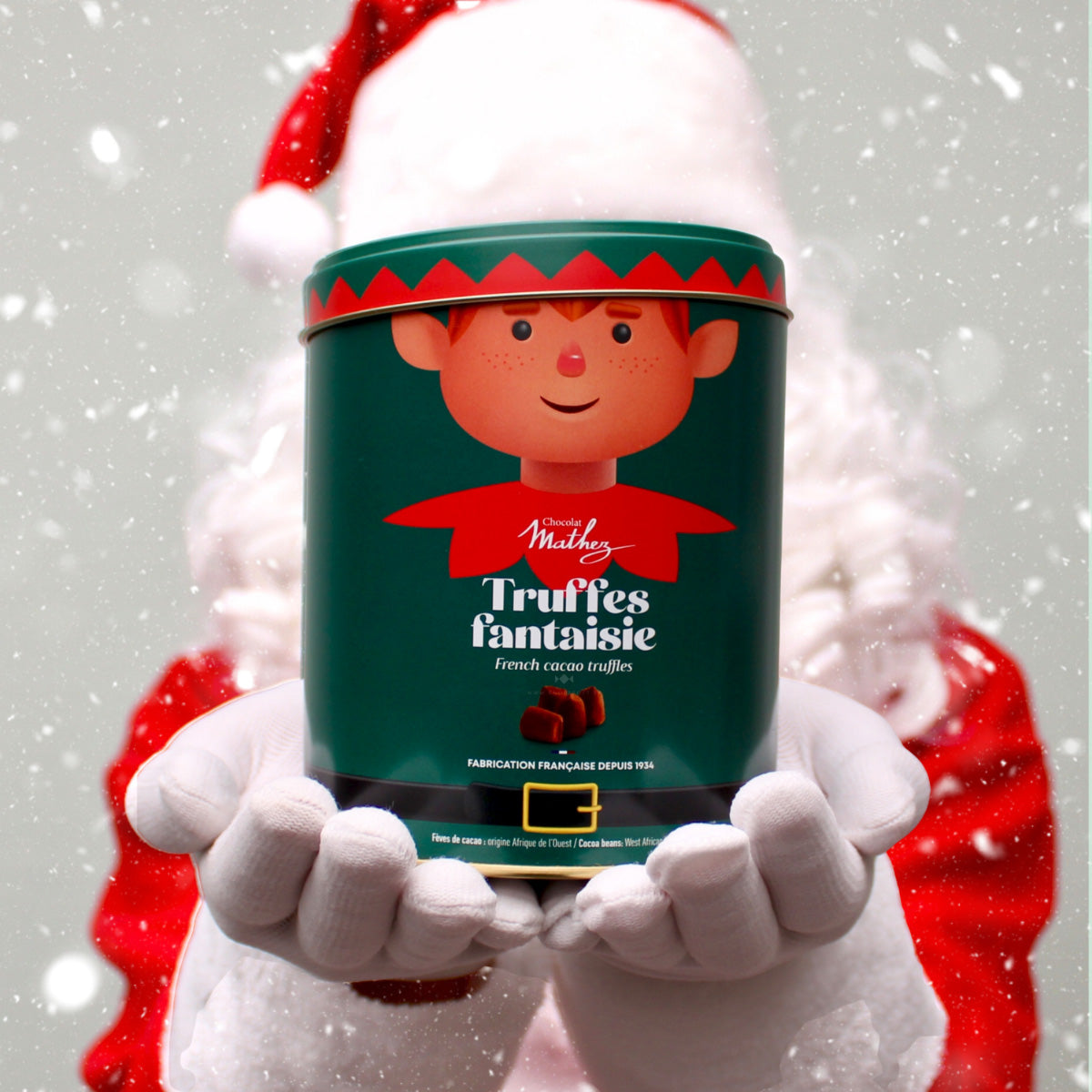 Tinnen kerstblik met afbeelding van kerstelfje, gevuld met Franse chocoladetruffels